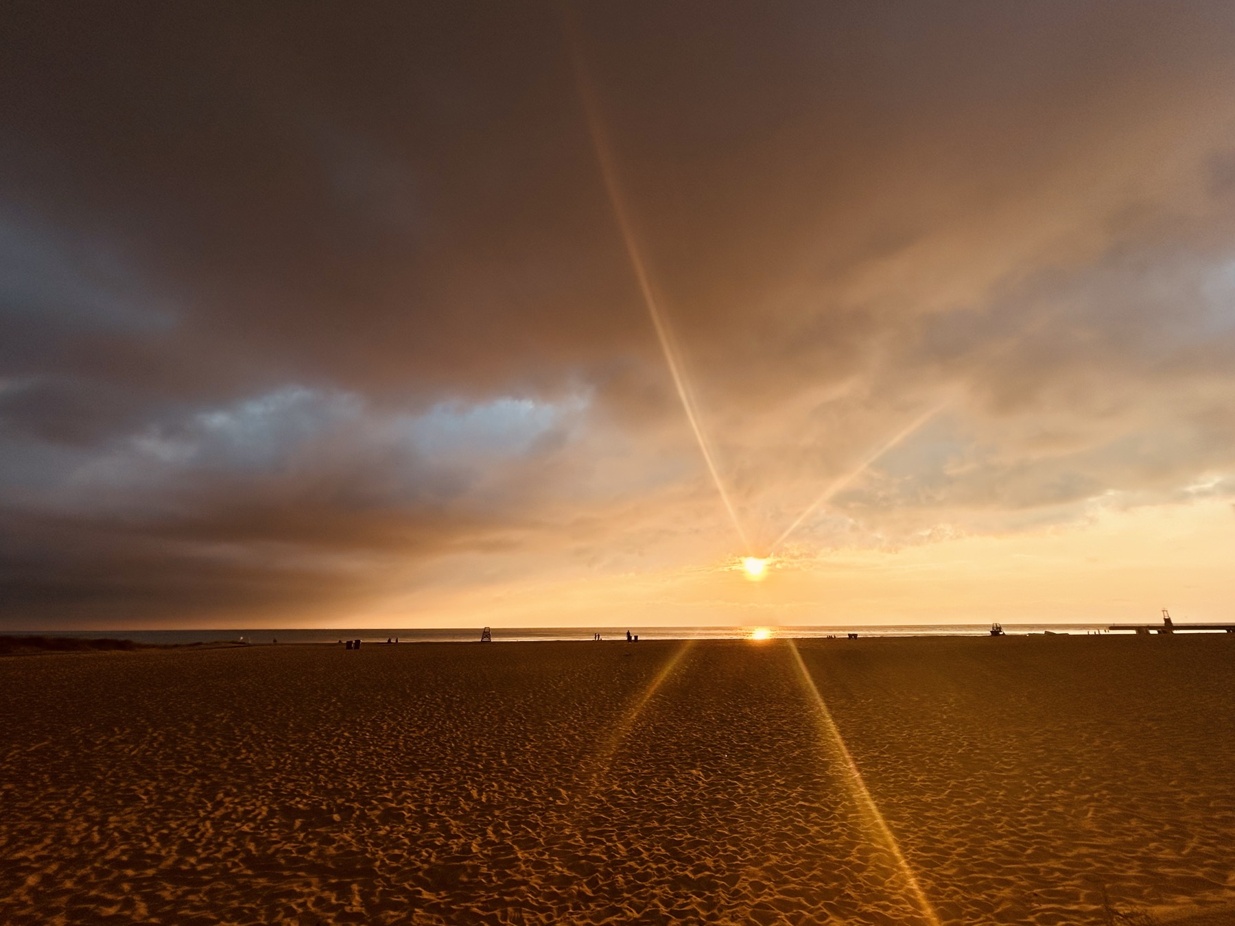 Kevin Halstead photograph: golden sunlight breaking through clouds above a beach
